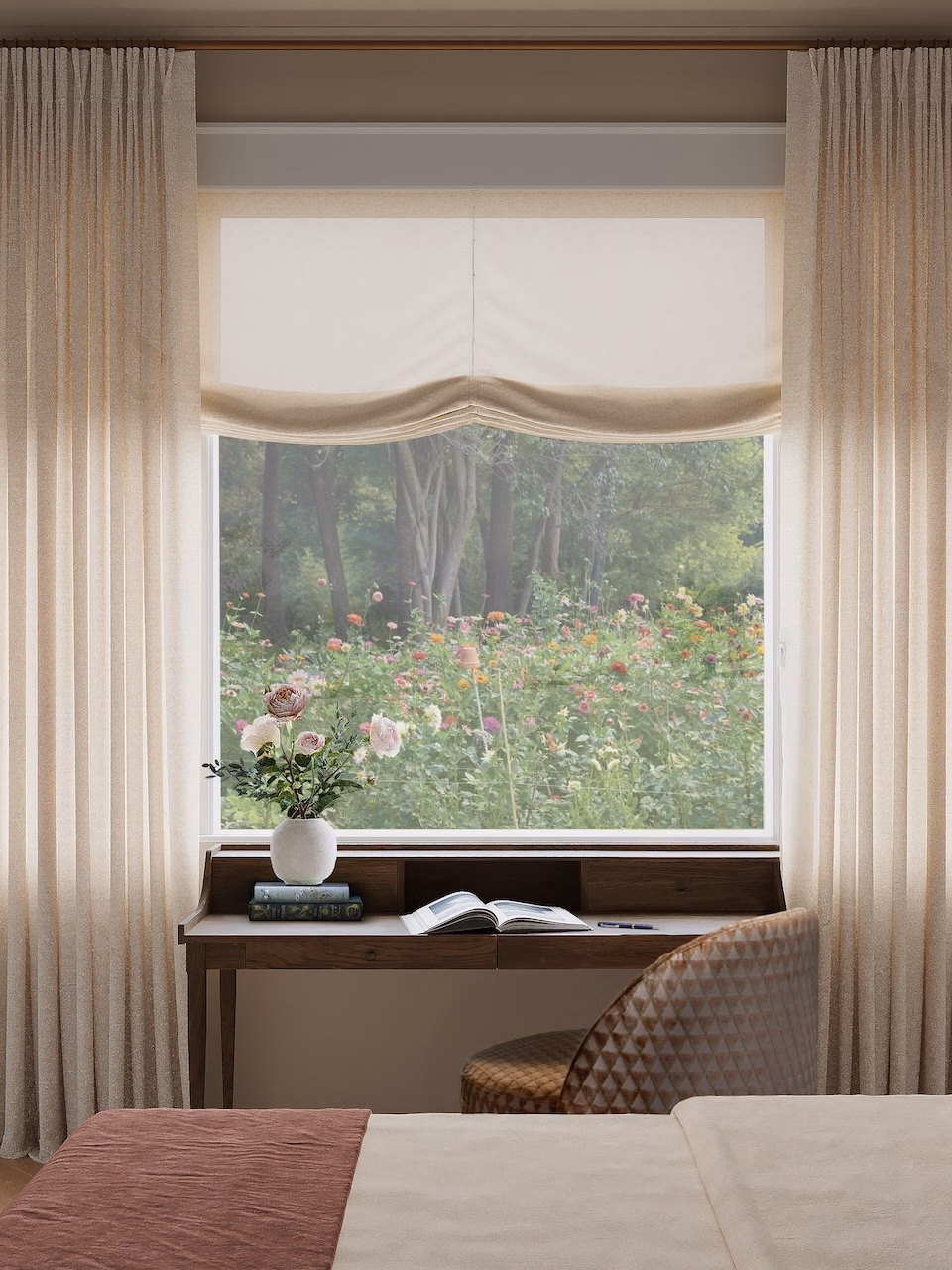 Dove privacy-lined pinch pleat linen drapes frame a relaxed Roman shade and garden-facing bedroom window.
