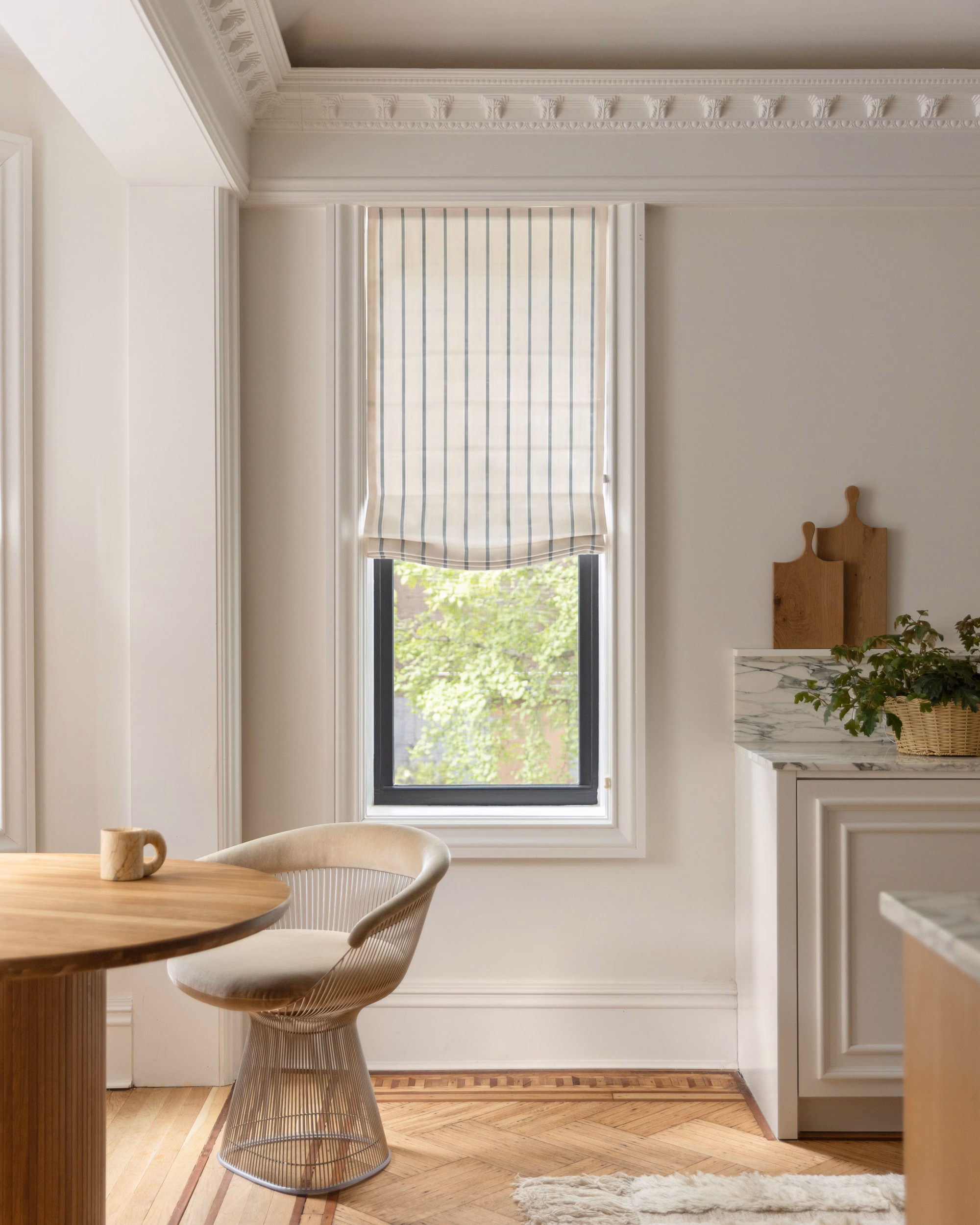 Marina striped privacy-lined relaxed Roman shade adds tailored pattern and privacy to a bright kitchen window.