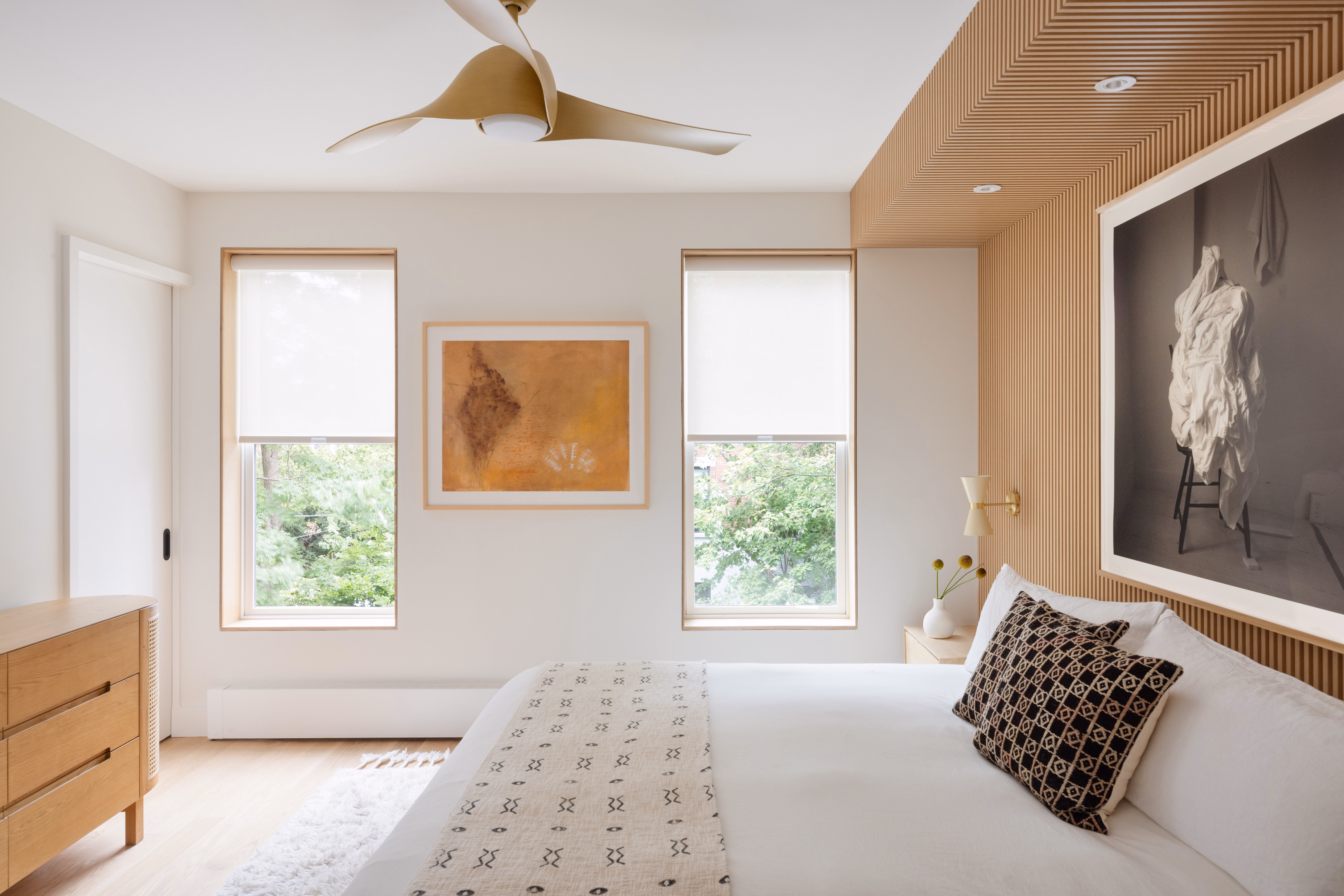 Light filtering roller shades in a bedroom