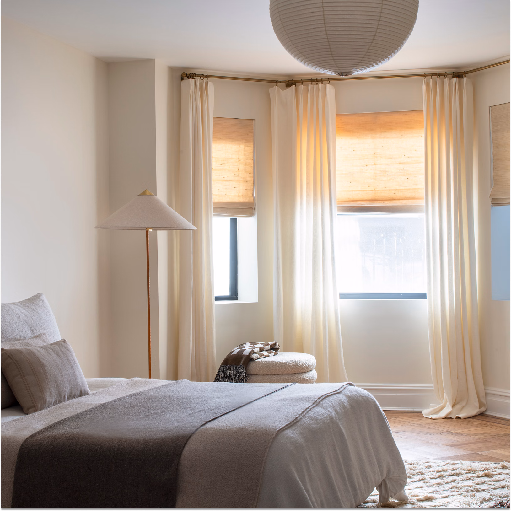 Woven wood window shades in a modern bedroom with natural light, soft textures, and eco-friendly décor.
