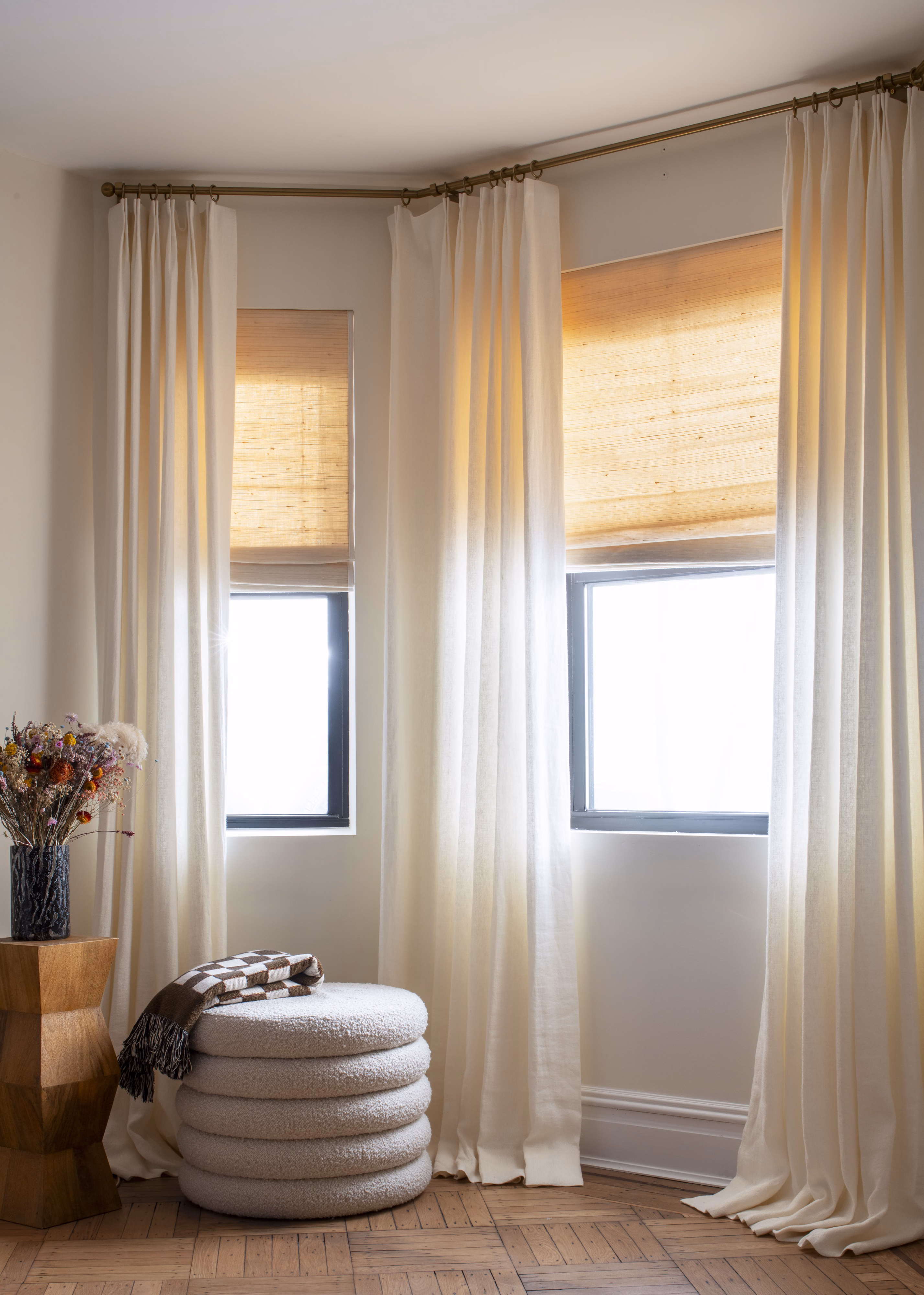 Custom woven wood shades used with custom drapery to reduce energy bills while creating a beautiful atmosphere.